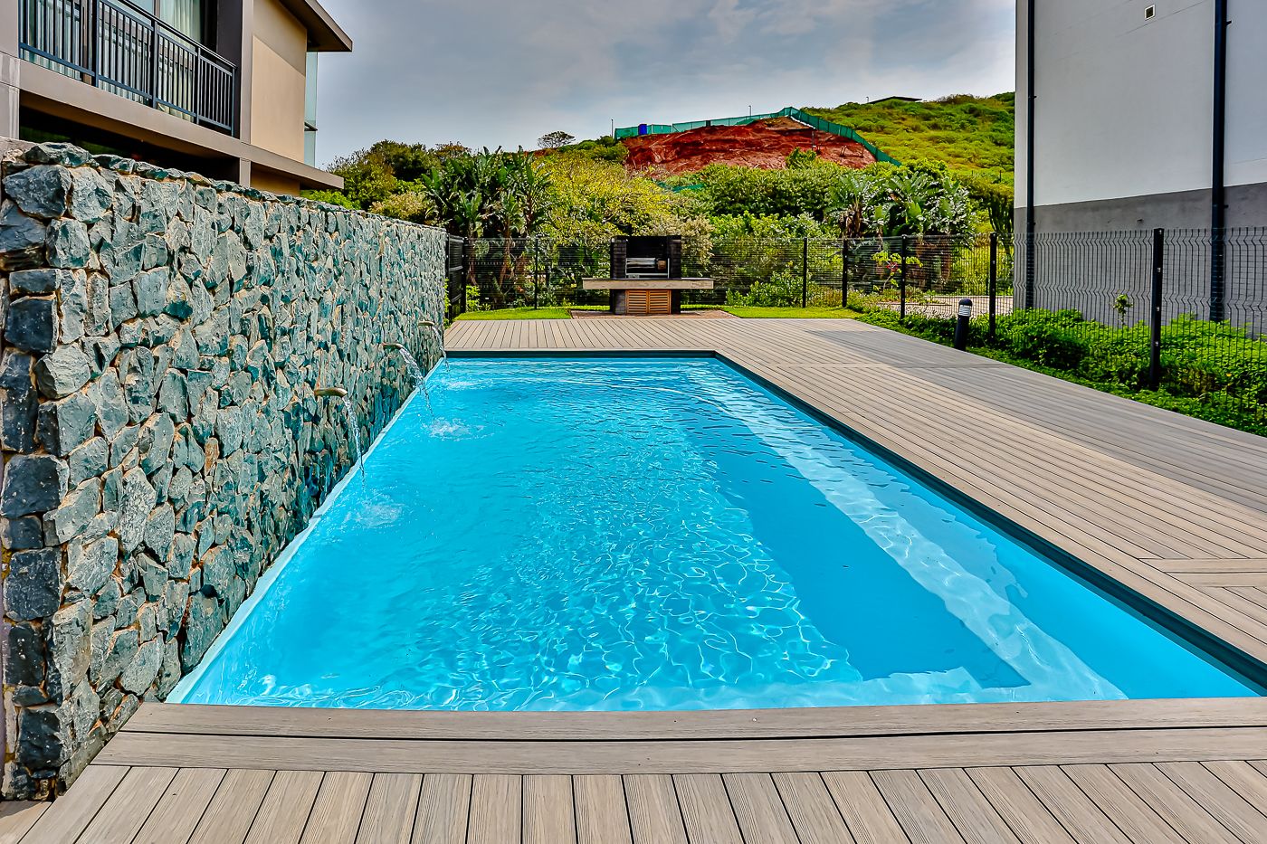 The pool at Boulevard Edge, with a braai at the far end of the deck